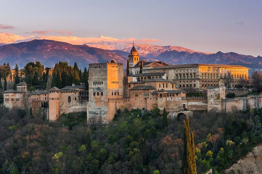 Arabic palace Alhambra in Granada,Spain at twilight with Sierra Nevada mountains in background