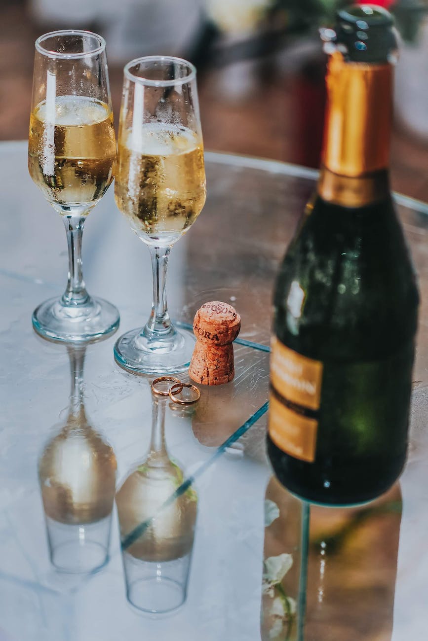 open champagne bottle near two cocktail glasses